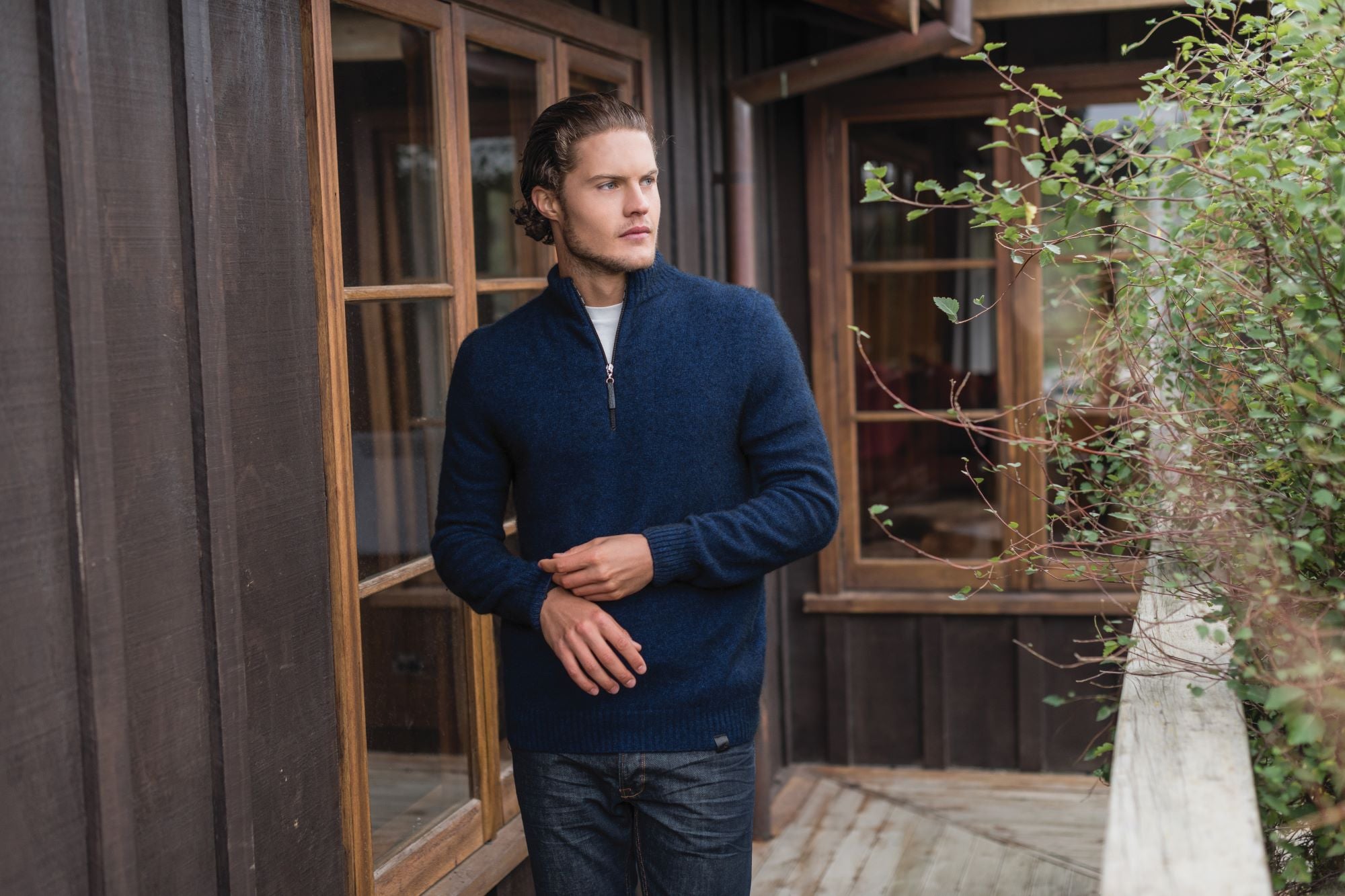 Man with a wool jacket in front of a batch