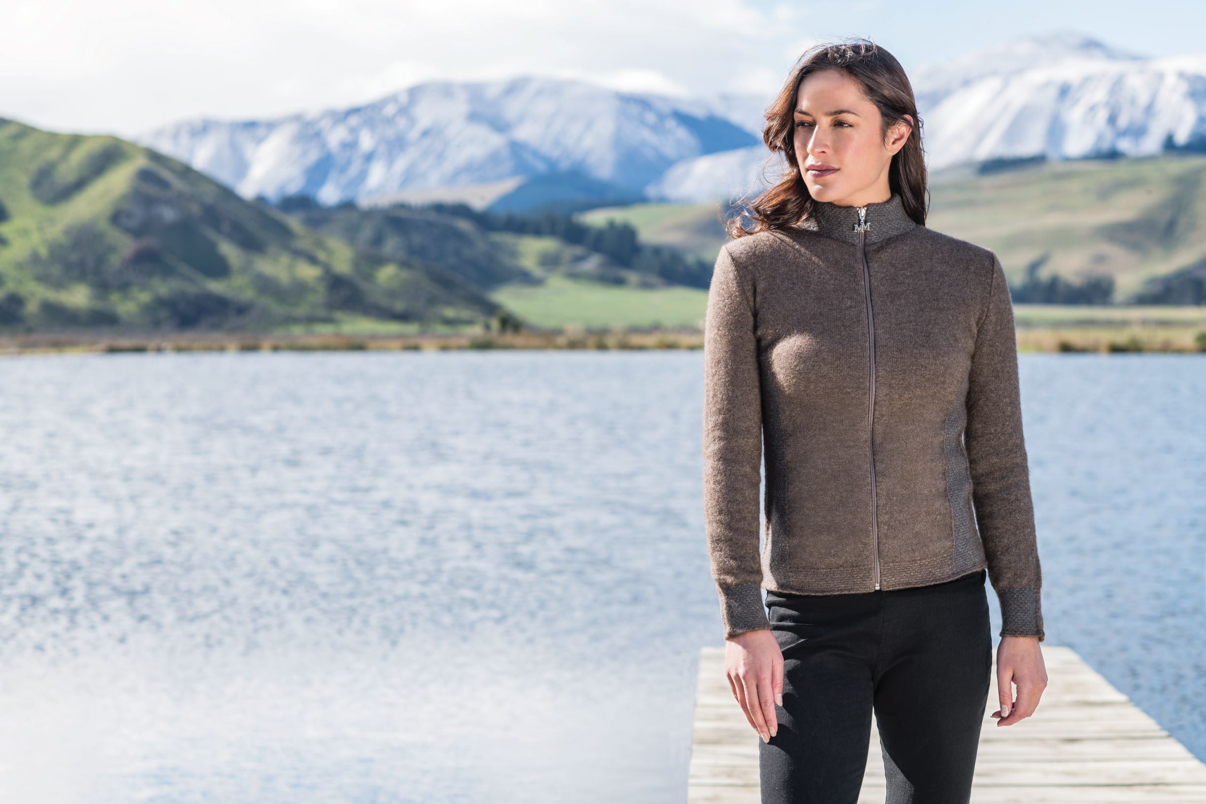 possum merino jacket made in New Zealand in front of a lake and stunning mountains